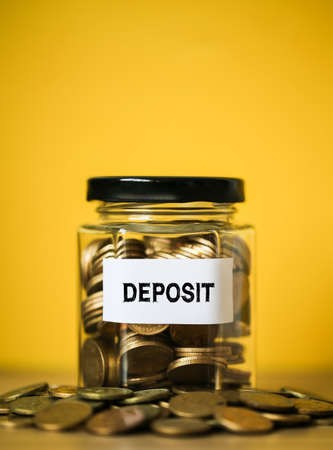 Deposit concept glass jar with a lot of coins inside.の写真素材
