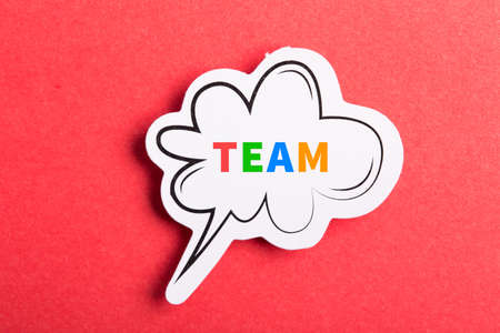 Team colorful text speech bubble isolated on red background about Teamwork concept.の写真素材