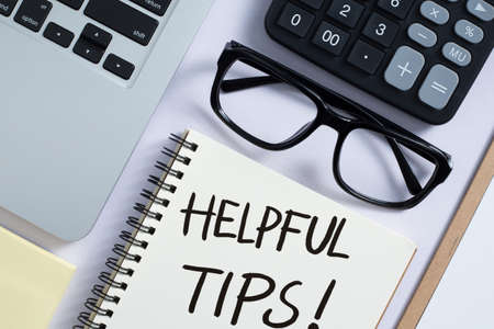 Helpful Tips concept on desktop workspace with office supplies.の写真素材