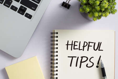 Helpful Tips concept on desktop workspace with office supplies.の写真素材