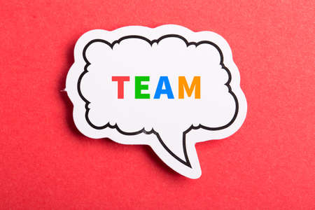 Team colorful text speech bubble isolated on red background about Teamwork concept.の写真素材