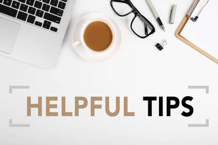 Helpful Tips concept on desktop workspace with office supplies.の写真素材