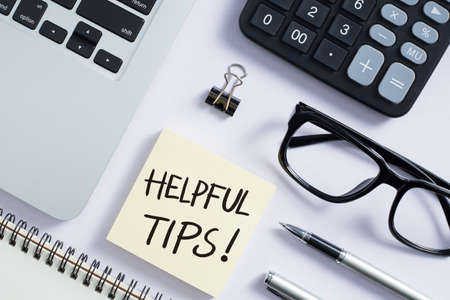 Helpful Tips concept on desktop workspace with office supplies.の写真素材