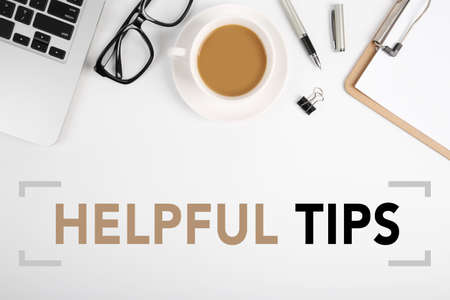 Helpful Tips concept on desktop workspace with office supplies.の写真素材