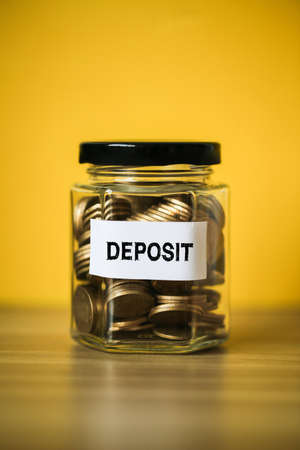 Deposit concept glass jar with a lot of coins inside.の写真素材