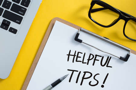 Helpful Tips concept on desktop workspace with office supplies.の写真素材