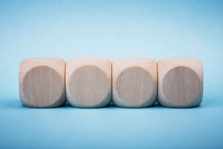 Four blank wooden blocks isolated on color background.の写真素材