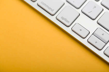Closeup Shot Of White Keyboard on yellow background.の写真素材