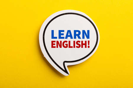Learn English speech bubble isolated on the yellow background.の写真素材