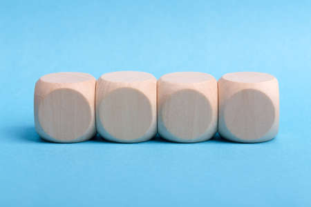 Four blank wooden blocks isolated on color background.の写真素材