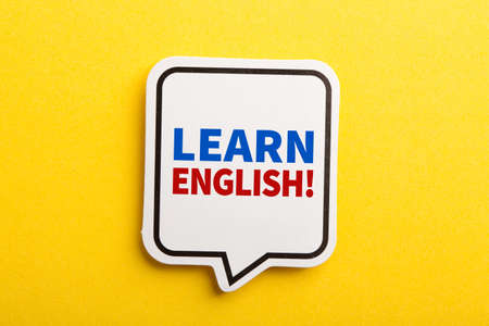 Learn English speech bubble isolated on the yellow background.の写真素材