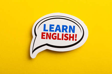 Learn English speech bubble isolated on the yellow background.の写真素材