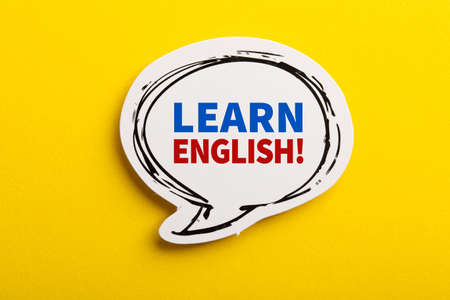 Learn English speech bubble isolated on the yellow background.の写真素材