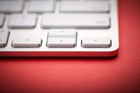 Closeup Shot Of White Keyboard on red background.の写真素材