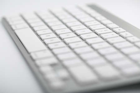 Closeup shot of white keyboard on white background.の写真素材