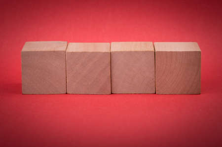 Four blank wooden blocks isolated on color background.の写真素材