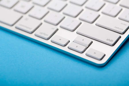 Closeup Shot Of White Keyboard on blue background.の写真素材