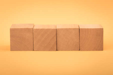 Four blank wooden blocks isolated on color background.の写真素材