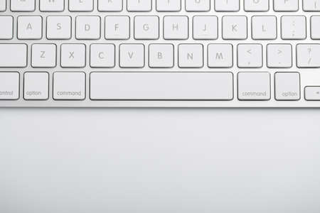 Closeup shot of white keyboard on white background.の写真素材