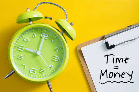Time is money concept with alarm clock aside.の写真素材