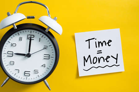 Time is money concept with alarm clock aside.の写真素材