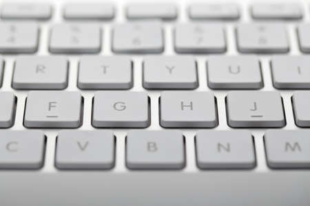 Closeup shot of white keyboard on white background.の写真素材