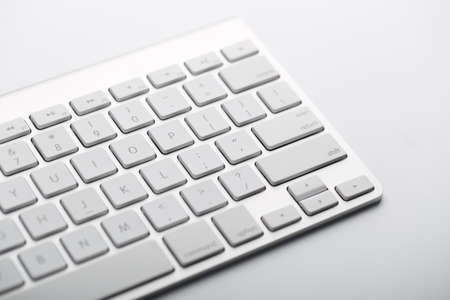 Closeup shot of white keyboard on white background.の写真素材