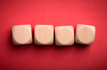 Four blank wooden blocks isolated on color background.の写真素材