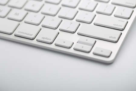 Closeup shot of white keyboard on white background.の写真素材