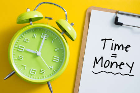 Time is money concept with alarm clock aside.の写真素材