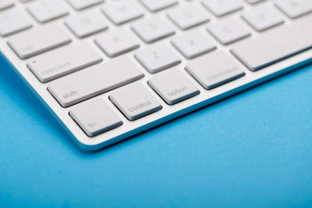 Closeup Shot Of White Keyboard on blue background.の写真素材