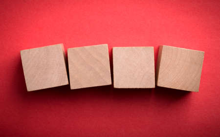 Four blank wooden blocks isolated on color background.の写真素材