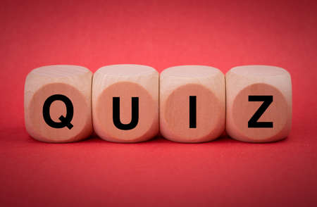 Quiz concept wooden blocks isolated on red background.の写真素材