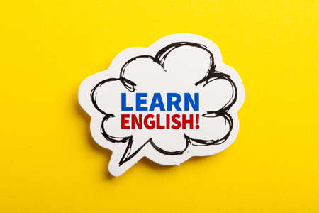 Learn English speech bubble isolated on the yellow background.の写真素材