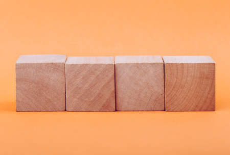 Four blank wooden blocks isolated on color background.の写真素材