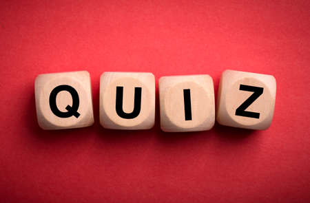 Quiz concept wooden blocks isolated on red background.の写真素材