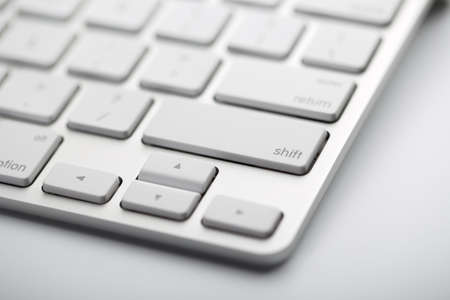 Closeup shot of white keyboard on white background.の写真素材