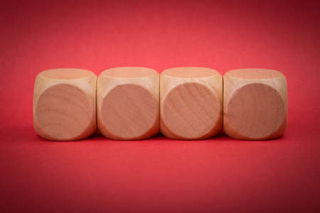 Four blank wooden blocks isolated on color background.の写真素材