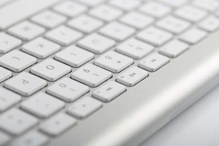 Closeup shot of white keyboard on white background.の写真素材
