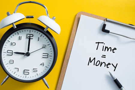Time is money concept with alarm clock aside.の写真素材