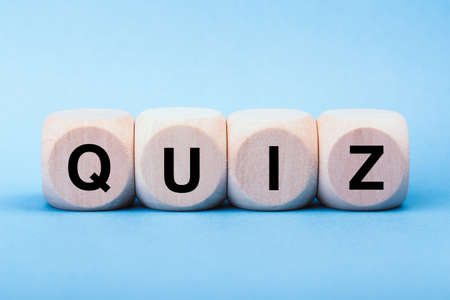 Quiz concept wooden blocks isolated on blue background.の写真素材