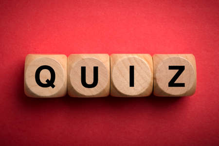 Quiz concept wooden blocks isolated on red background.の写真素材