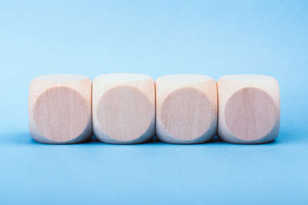 Four blank wooden blocks isolated on color background.の写真素材