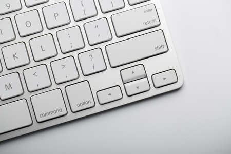 Closeup shot of white keyboard on white background.の写真素材