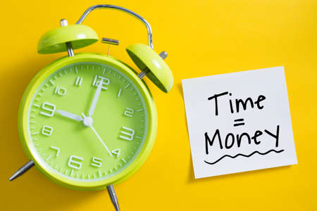 Time is money concept with alarm clock aside.の写真素材