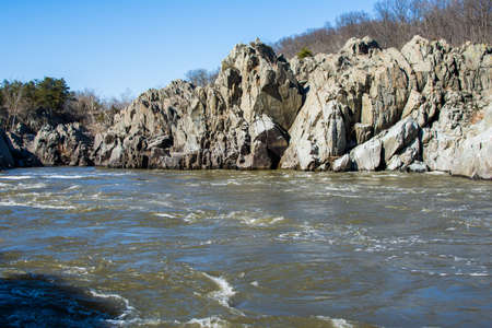 rushing white water in great falls park, virginia side in winterの写真素材