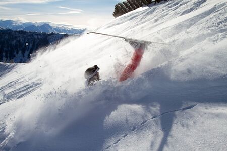skier crashes in Fresh Powderの写真素材