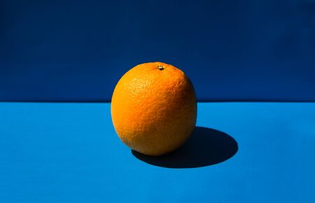 Fresh orange lying on a blue backgroundの写真素材