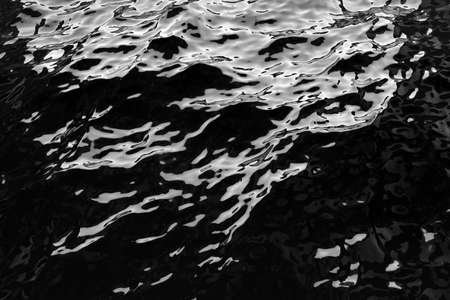 Black water surface. Abstract background. Black and white colors. High resolution.の写真素材