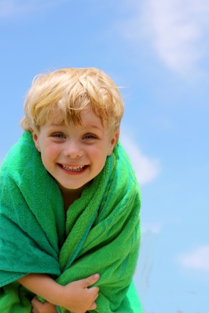 Super Cute and Happy Child in green Towelの写真素材
